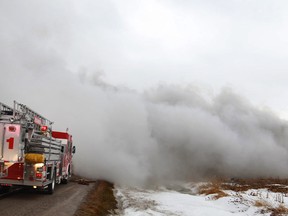 Tecumseh fire crews arrive at the scene of a home engulfed in smoke at 5033 Manning Rd., Saturday, Jan. 11, 2014.  No injuries were reported.  (DAX MELMER/The Windsor Star)