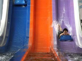 Kids take a ride down the Whizzard at the official opening of the Adventure Bay Family Water Park in downtown Windsor, Saturday, Jan. 18, 2014.   (DAX MELMER/The Windsor Star)