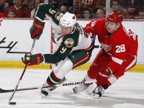 In this file photo, Detroit's Brian Rafalski, right, checks Minnesota's Mikko Koivu at Joe Louis Arena in 2010. (Photo by Gregory Shamus/Getty Images)