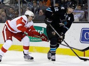 San Jose's Patrick Marleau, right, is checked by Detroit's Danny DeKeyser Thursday in San Jose. (AP Photo/Marcio Jose Sanchez)