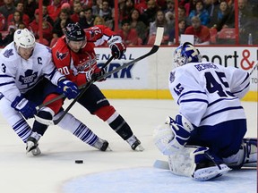 Toronto's Dion Phaneuf, left, checks Washington's Troy Brouwer in front of goalie Jonathan Bernier Friday in Washington. (Photo by Rob Carr/Getty Images)