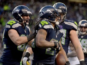 LaSalle's Luke Willson, left, congratulates running back Marshawn Lynch after Lynch scored a 31-yard touchdown against the New Orleans Saints in the fourth quarter at CenturyLink Field in Seattle. (Photo by Harry How/Getty Images)