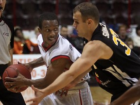 Windsor's Stefan Bonneau, left, is guarded by London's Greg Surmacz at the WFCU Centre. (DAN JANISSE/The Windsor Star)