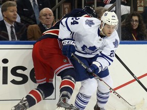 Toronto's Peter Holland, right, is checked by New York's John Moore at Madison Square Garden. (Photo by Bruce Bennett/Getty Images)