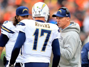 Chargers offensive co-ordinator Ken Whisenhunt, right, talks to quarterback Philip Rivers against the Bengals. (Photo by Rob Carr/Getty Images)