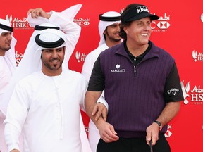 Phil Mickelson joins local dancers prior to the start of the Abu Dhabi HSBC Golf Championship at the Abu Dhabi Golf Cub Tuesday in Abu Dhabi, (Photo by Andrew Redington/Getty Images)
