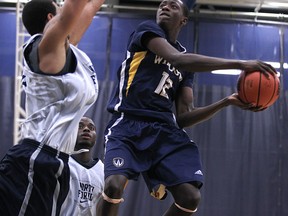 Windsor's Rotimi Osuntola Jr., right, is guarded by North Florida's Andy Diaz in 2011. (DAX MELMER/The Windsor Star)