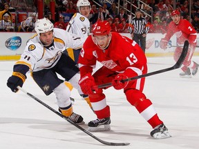 Detroit's Pavel Datsyuk, right, is checked by Nashville's David Legwand at Joe Louis Arena. (Photo by Gregory Shamus/Getty Images)