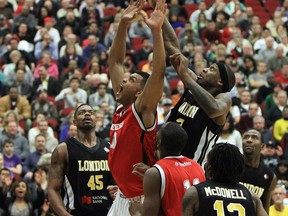 Windsor's Kevin Loiselle scores on a rebound in front of London's Darin Mency during the Clash at the Colosseum at Caesars Windsor.         (TYLER BROWNBRIDGE/The Windsor Star)