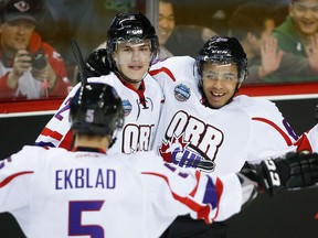 Spits forward Josh Ho-Sang, right, celebrates his goal with teammate Alex Peters, centre, and Belle River's Aaron Ekblad at the CHL Top Prospects game in Calgary Wednesday. (THE CANADIAN PRESS/Jeff McIntosh)