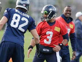 LaSalle's Luke Willson, left, talks to Seahawks quarterback Russell Wilson at practice Wednesday in Renton, Wash. (AP Photo/Ted S. Warren)