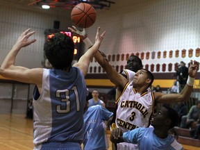 Catholic Central's Eriq Jenkins, right, battles for the ball with St. Michaels' Danilo Djuricic, left, at the Freeds Tip Off Tournament at Catholic Central. (DAX MELMER/The Windsor Star)