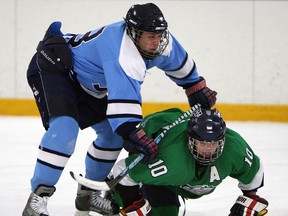 Massey's Brandon Carr, left, checks Herman's Liam MacDonald at Adie Knox Arena Thursday. (TYLER BROWNBRIDGE/The Windsor Star)