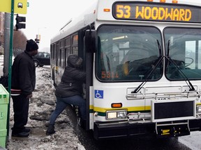 Detroit residents Derrick Lunford, left, and Kim Lewis take the Woodward Avenue bus near Bethune Avenue West on  January 18, 2011. (NICK BRANCACCIO /The Windsor Star)
