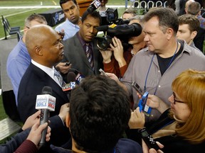 Lions head coach Jim Caldwell, left, talks with reporters following his introduction at a news conference at Ford Field. (Photo by Duane Burleson/Getty Images)