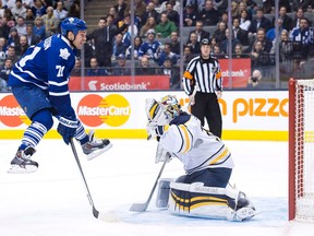 Toronto's David Clarkson, left, screens Buffalo goalie Ryan Miller Wednesday in Toronto. (THE CANADIAN PRESS/Nathan Denette)