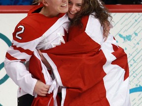 Ruthven's Meghan Agosta-Marciano, left, celebrates with Team Canada goalie Shannon Szabados following their victory over the USA in the gold medal game in Vancouver. (John Mahoney/Canwest News Service).