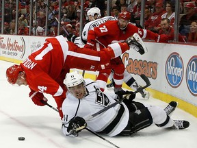 Detroit's Gustav Nyquist, left, is checked by Kings centre Anze Kopitar Saturday at Joe Louis Arena. (Photo by Leon Halip/Getty Images)