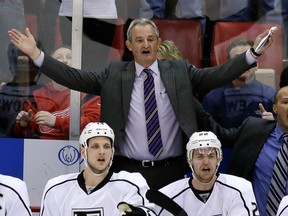 Los Angeles Kings head coach Darryl Sutter, top, reacts after the Detroit Red Wings were awarded the tying goal even though the puck went off the netting behind the goal and into the Los Angeles goal. (AP Photo/Carlos Osorio)