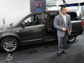 Reid Bigland, President and CEO - Chrysler Canada Inc., is shown in front of a Dodge Grand Caravan at the North American International Auto Show in Detroit, on Tuesday, Jan. 14, 2014.  (DAN JANISSE/The Windsor Star)