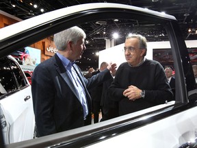 Michigan Gov. Rick Snyder, left, talks with Chrysler CEO Sergio Marchionne at the North American International Auto Show in Detroit on Tuesday, Jan. 14, 2014.  (DAN JANISSE/The Windsor Star)