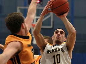 Windsor's Mike Rocca is challenged by Waterloo's Mike Helsby, left, as the Windsor Lancers men's basketball host the Waterloo Warriors at the St. Denis Centre, Sunday, Jan. 26, 2014.   (DAX MELMER/The Windsor Star)