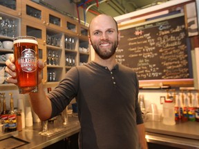 Ben Davidson, owner of the Green Bean Cafe holds up a glass of Walkerville beer which is now available in the Windsor Star News Cafe. (DAN JANISSE/The Windsor Star)