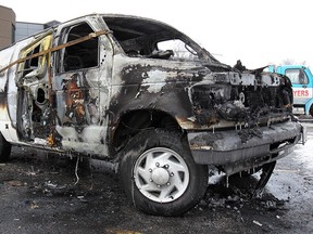 The remains of a van destroyed by fire in a parking lot at 3335 Dougall Ave. in Windsor, Ont. on Jan. 21, 2014. (Dan Janisse / The Windsor Star)