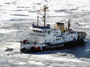 In this Jan. 18, 2004 file photo, unidentified debris from a plane sits above the ice, left, as the US Coast Guard Cutter Neah Bay posts itself Sunday outside of the site where a charter flight from Pelee Island to Windsor Airport crash-landed about a half-a-mile off the island into Lake Erie, killing 10 people. (Tim Fraser/Windsor Star)