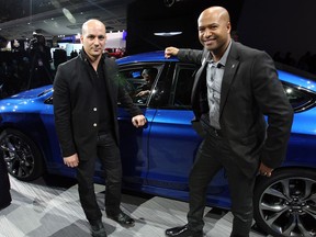 Chrysler designers Jeff Hammoud, left, and Ralph Gilles, both Canadians, made huge contributions to the new Chrysler 200, shown behind, during North American International Auto Show unveiling at Detroit's Cobo Center, Jan. 13, 2014. (NICK BRANCACCIO/The Windsor Star)