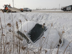 Tow truck operators were kept busy Monday, Jan. 6, 2014, as roads were slick with drifting snow. Here a car is removed from a ditch on Manning Road north of County Road 42. No one was injured in the early afternoon accident. (DAN JANISSE/The Windsor Star)