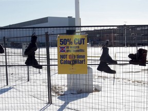 In this file photo, boots hang on the fence surrounding the Electro-Motive Canada plant  in London, Ont., on Feb. 13, 2012.   (JASON KRYK/  The Windsor Star)