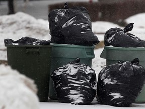 Garbage bags are shown on Frank Avenue on Thursday, Jan. 16, 2014, in Windsor, Ont. As of March 1, 2014, crews will no longer pick up garbage in bags. (DAN JANISSE/The Windsor Star)