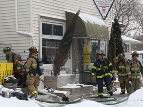 Windsor firefighters are shown at the scene of a fire, Thursday, Jan. 23, 2014, in the 1200 block of George Ave. in Windsor, Ont. A cooking accident is being blamed for the fire at the jewelry and knick-knack store. (DAN JANISSE/The Windsor Star)