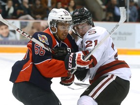 Windsor's Josh Ho-Sang, left, is checked by Guelph's Brock McGinn at the Sleeman Centre. (Tony Saxon/Guelph Mercury)