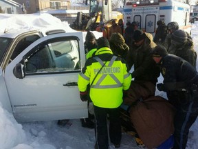 Emergency crews free a man from a vehicle trapped in the snow in Leamington overnight. (TwitPic: Jason Kryk/The Windsor Star)