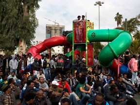 African migrants listen to speakers during a protest in Lewinsky park in Tel Aviv, Israel, Thursday, Jan. 9, 2014. The migrants, some of whom are menial labourers in Israel, have been on a five-day strike. About 60,000 African migrants, mostly from Sudan and Eritrea, have trekked through Egypt and other Muslim countries to reach Israel in recent years. Some are fleeing violence or oppression in their home countries while others are seeking better economic opportunities. (AP Photo/Oded Balilty)