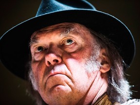 Singer Neil Young speaks during a press conference for the "Honour the Treaties" tour, a series benefit concerts being held to raise money for legal fight against the expansion of the Athabasca oilsands in northern Alberta and other similar projects, in Toronto, Sunday January 12, 2014. (THE CANADIAN PRESS/Mark Blinch)
