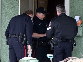 Windsor Police investigate at 929 Moy Avenue after a Canada Post employee alerted Windsor Police about mail stacking up January 31, 2014. Later, police and Essex-Windsor EMS paramedics found the bodies of two, elderly brothers inside the unheated home. (NICK BRANCACCIO/The Windsor Star)