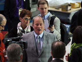 Detroit Mayor Mike Duggan, centre, and local media, take a tour and sneak preview of North American International Auto Show at Detroit's Cobo Center, Thursday January 9, 2014. (NICK BRANCACCIO/The Windsor Star)