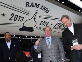 Detroit Mayor Mike Duggan, centre, is escorted through Chrysler exhibits by Phil Bockhorn, right, of Chrysler Group, during a tour and sneak preview of North American International Auto Show at Detroit's Cobo Center, Thursday January 9, 2014. (NICK BRANCACCIO/The Windsor Star)