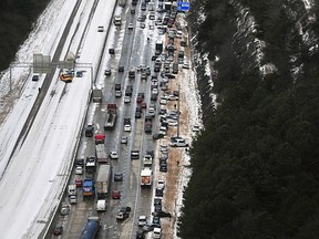 This aerial photo shows stranded vehicles on I-65 near Hoover, Ala., Wednesday, Jan. 29, 2014. A winter storm dumped snow in central and southern Alabama yesterday. (AP Photo/AL.com, Tamika Moore)