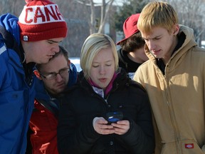 Riverside High School students Jake Jubinville, left, Julian Bernon, Christopher Steinhoff, Harley Covey and Jacob Stewart, right, gather outside of classes and reviewed texts and tweets following an incident where Windsor Police were called to the scene Thursday January 23, 2014. (NICK BRANCACCIO/The Windsor Star)