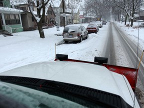 Dan Martinello, a City of Windsor snowplow operator, removes snow from city streets Sunday, Jan. 5, 2014.  (DAX MELMER/The Windsor Star)