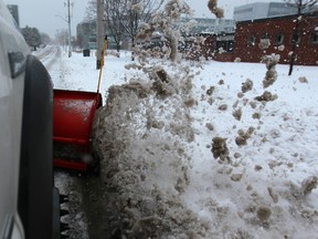 Dan Martinello, a City of Windsor snowplow operator, removes snow from city streets Sunday, Jan. 5, 2014.  (DAX MELMER/The Windsor Star)