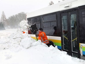 A Transit Windsor crew works to free a bus stuck in the snow on Riverside Drive near Sandpoint Beach in Windsor on Thursday, January 2, 2014.                       (TYLER BROWNBRIDGE/The Windsor Star)