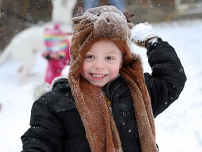 Lucas Power, 5, enjoys his snowy ride home from school with sister Harmony on Moy Avenue Thursday, January 16, 2014. (NICK BRANCACCIO/The Windsor Star)