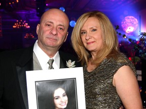 Leonardo and Sylvia Scurto hold a picture of their 18-year-old daughter, Mikaela, at the 17th annual Transition to Betterness gala at the Ciociaro Club Saturday, Jan. 25, 2014. Mikaela, a St. Anne Catholic high school student, died from cancer in September 2013. (JOEL BOYCE/The Windsor Star)