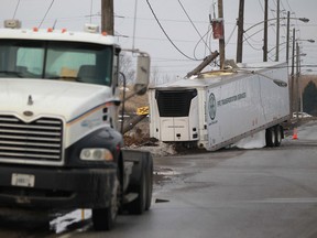 A semi-truck rests detached from its trailer after striking a hydro pole at the intersection of Ojibway Parkway and Broadway Boulevard, Tuesday, Jan. 14, 2014.  (DAX MELMER/The Windsor Star)
