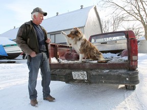 Jon Parks is shown with his Australian shepherd named Pupdog, Thursday, Jan. 9, 2014, at his Amherstburg, Ont. farm. Parks says he thinks the town of Essex which is predominately rural should amend its bylaw to allow working farm dogs to ride in the back of trucks that are licensed as farm vehicles. (DAN JANISSE/The Windsor Star)